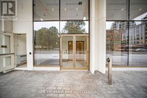 Toronto (Annex) condo for rent - The entrance to a building with a glass door and a sign that reads "13th St.".