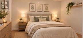 Toronto (Waterfront Communities) condo for rent - A bedroom with a bed, nightstands, and framed pictures on the wall.