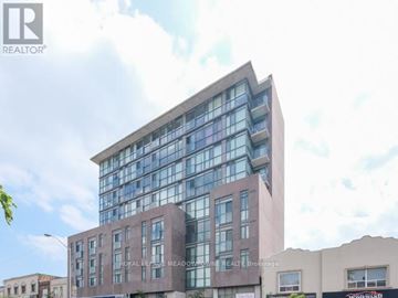Toronto (Woodbine Corridor) condo for rent - A modern building with a glass facade is the main focus of the image.