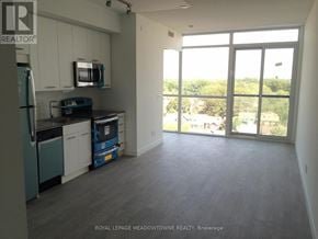 Toronto (Woodbine Corridor) condo for rent - A kitchen with a refrigerator, microwave, and dishwasher.
