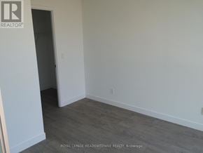 Toronto (Woodbine Corridor) condo for rent - A room with a doorway leading to another room.