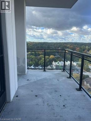 Waterloo condo for rent - A balcony with a view of a cloudy sky and trees.