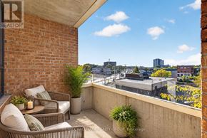 Ottawa condo for rent - A balcony with a table and chairs overlooking a cityscape.