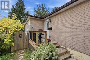 Guelph (Grange Road) apartment for rent - A house with a wooden fence and a small patio area.