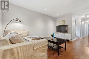 Guelph (Grange Road) apartment for rent - A living room with a couch, a coffee table, and a television.