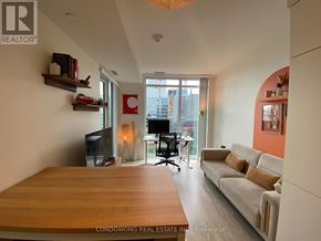Toronto (Waterfront Communities) condo for rent - A modern living room with a large wooden table and a couch.