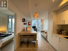 Toronto (Waterfront Communities) condo for rent - A well-lit apartment with a kitchen area and a dining table.