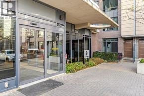 Toronto (Islington-City Centre West) condo for rent - The front of a building with a glass door and a sign that says REALTOR.