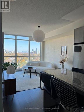 Toronto (Islington-City Centre West) condo for rent - A living room with a view of the city skyline.