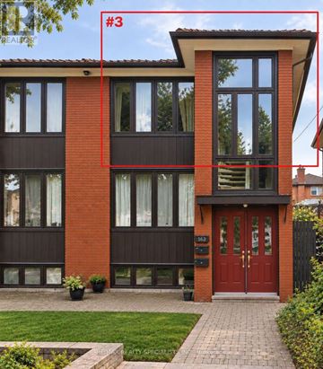 Toronto (Corso Italia-Davenport) triplex for rent - A red and brown building with a red door and windows.