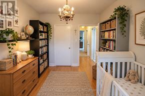 Toronto (Corso Italia-Davenport) triplex for rent - A nursery room with a crib and a chandelier.
