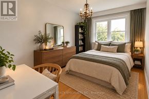 Toronto (Corso Italia-Davenport) triplex for rent - A well-lit bedroom with a large bed, a wooden dresser, and a chandelier.