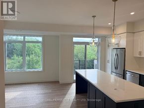 Guelph (Riverside Park) townhouse for rent - A kitchen with a white countertop and a refrigerator.