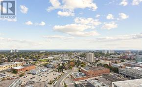 Kitchener condo for rent - A cityscape with buildings and a clear sky.