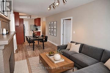 Windsor apartment for rent - A living room with a grey couch and a coffee table in the middle.