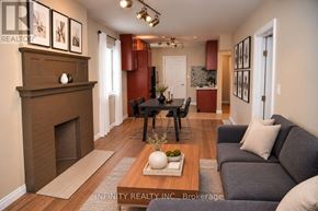 Windsor apartment for rent - A living room with a fireplace and a dining table.
