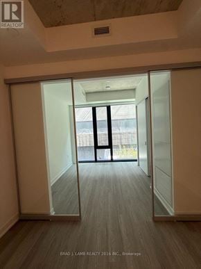 Toronto (Kensington-Chinatown) condo for rent - A room with a sliding door leading to a balcony.