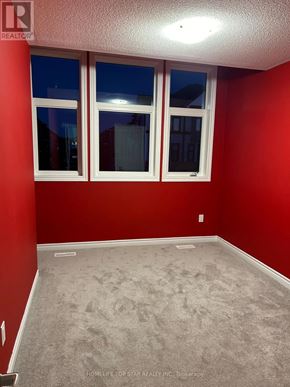 Oshawa (Donevan) townhouse for rent - A room with red walls and carpeted floor.
