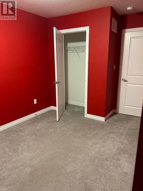 Oshawa (Donevan) townhouse for rent - A room with red walls and a white door.