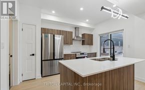 Barrie apartment for rent - A modern kitchen with a large island and stainless steel appliances.