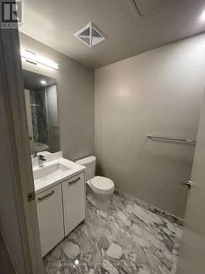 Toronto (Waterfront Communities) condo for rent - A bathroom with a marble floor and white walls.