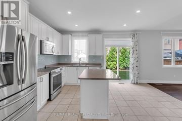 Georgina (Keswick South) apartment for rent - A modern kitchen with white cabinets and stainless steel appliances.