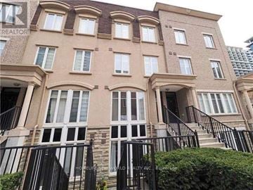 Toronto (Niagara) townhouse for rent - A building with a sign that says "Honest Realty Inc." on the front.