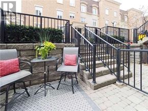 Toronto (Niagara) townhouse for rent - A patio with a table and chairs and a black railing.