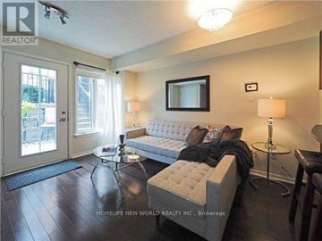 Toronto (Niagara) townhouse for rent - A living room with a white couch and a coffee table.