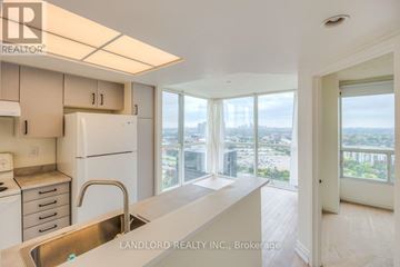 Toronto (Banbury-Don Mills) townhouse for rent - A kitchen with white appliances and a view of the city.