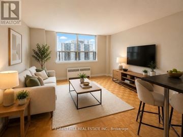 Toronto (North St. James Town) house for rent - A living room with a couch, a coffee table, a television, and a window with a view of a cityscape.