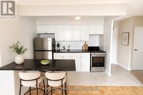 Toronto (North St. James Town) house for rent - A modern kitchen with Forest Hill Real Estate Inc. logo on the bottom left.