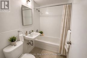 Toronto (North St. James Town) house for rent - A white bathroom with a toilet, sink, and bathtub.