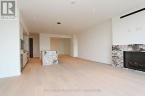 Toronto (Annex) condo for rent - A spacious living room with a fireplace and a large painting on the wall.
