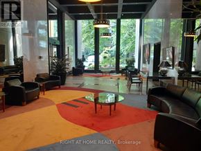 Toronto (Waterfront Communities) condo for rent - A large room with a red rug and leather couches.