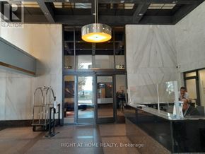 Toronto (Waterfront Communities) condo for rent - A brokerage office with a reception desk and a person standing behind it.