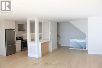 Toronto (Waterfront Communities) condo for rent - A modern kitchen with white cabinets and appliances.