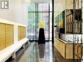 Toronto (Annex) condo for rent - A hallway with a bench and a woman standing in the doorway.