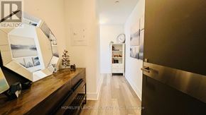 Toronto (Annex) condo for rent - A hallway with a clock on the wall and a Christmas tree on the floor.