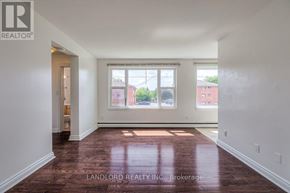 Whitby (Downtown Whitby) multi-family for rent - A room with a brown floor and white walls.