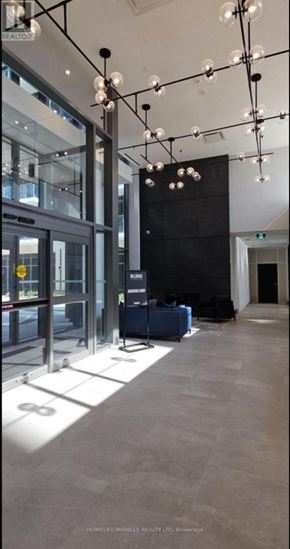 Milton (Tm Timberlea) condo for rent - A modern office lobby with a glass wall and a black wall.
