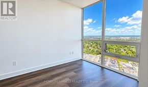 Milton (Tm Timberlea) condo for rent - A room with a view of a parking lot through the window.