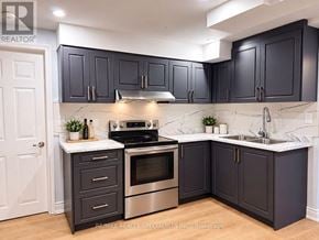 Oakville (Ga Glen Abbey) apartment for rent - A kitchen with dark cabinets and a stainless steel oven.
