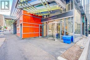 Toronto (Bay Street Corridor) condo for rent - A realtor office is located in a modern building with a glass facade.