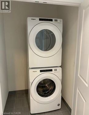 Brantford townhouse for rent - Two white front load washing machines stacked on top of each other in a laundry room.