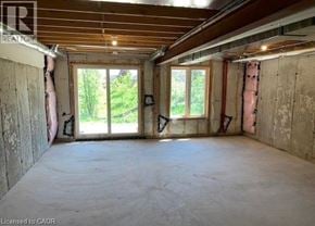 Brantford townhouse for rent - A room under construction with exposed wooden beams and unfinished walls.