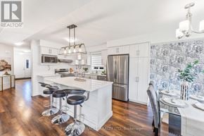 Stratford apartment for rent - A modern kitchen with white cabinets and a central island.