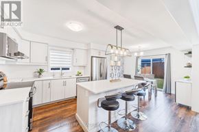 Stratford apartment for rent - A well-lit kitchen with white cabinets and a central island.