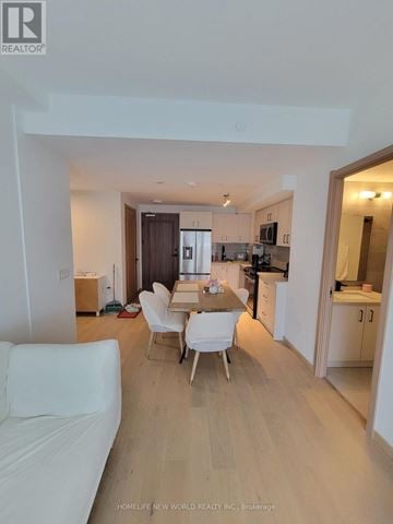 Toronto (Tam O'shanter-Sullivan) condo for rent - A white couch is in the living room of a newly remodeled apartment.