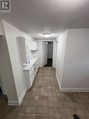 Newmarket (Bristol-London) apartment for rent - A hallway with white walls and tiled flooring.